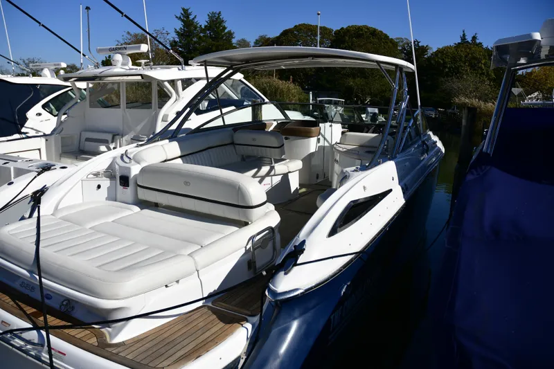 Slide: The Image of 2016 Cobalt 336 boat docked, featuring spacious seating and sleek design. - 1