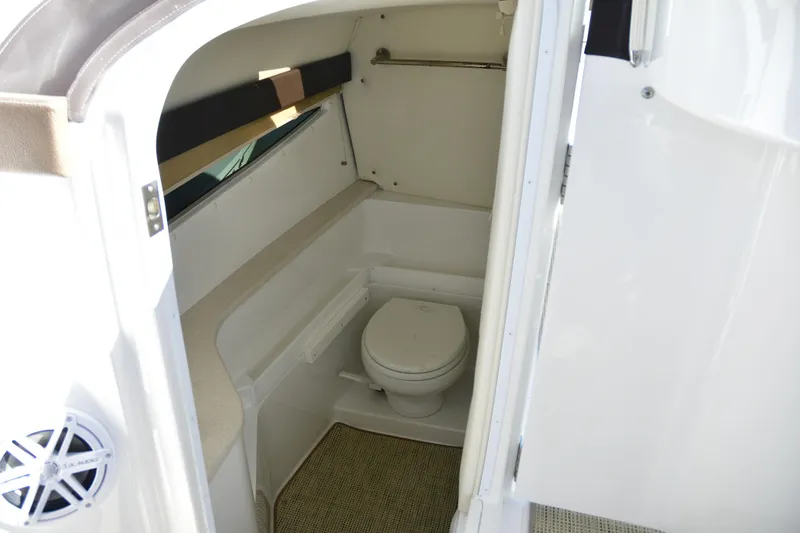 Slide: The Image of Interior of 2016 Cobalt 336 boat bathroom with toilet and window. - 13