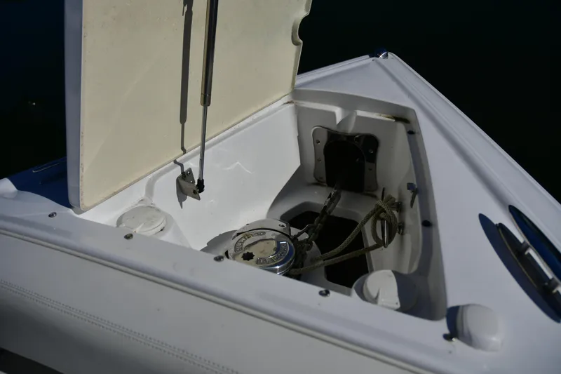 Slide: The Image of Open anchor compartment on 2016 Cobalt 336 boat, showing ropes and mechanism. - 16