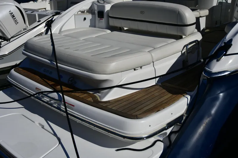 Slide: The Image of 2016 Cobalt 336 boat with white seating and wooden deck details. - 2