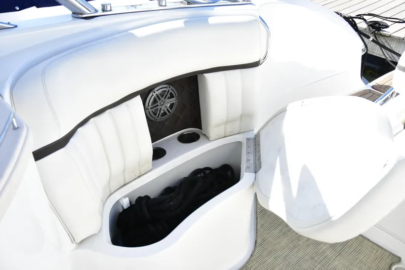 Slide: The Image of 2016 Cobalt 336 boat interior with white seating and storage compartment. - 4