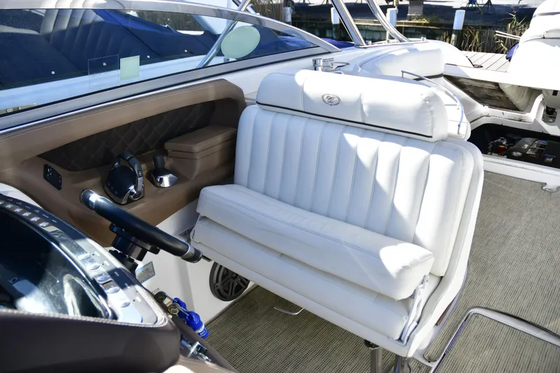 Slide: The Image of Interior of 2016 Cobalt 336 boat with white leather seating and steering controls. - 6