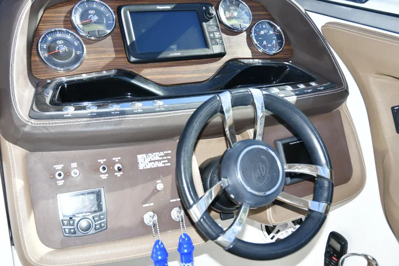 Slide: The Image of Dashboard of a 2016 Cobalt 336 boat with steering wheel and gauges. - 8