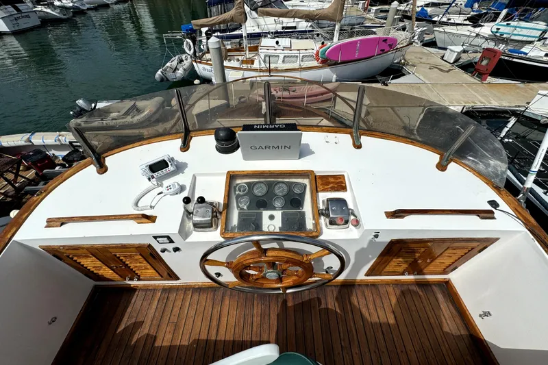 Slide: The Image of Aft cabin of 1985 PT Boats PT 38, featuring wooden helm and navigation equipment. - 10