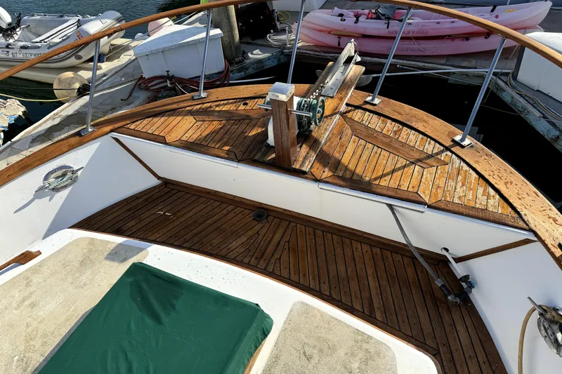 Slide: The Image of Aft cabin of 1985 PT Boats PT 38, featuring wooden deck and railing. - 12