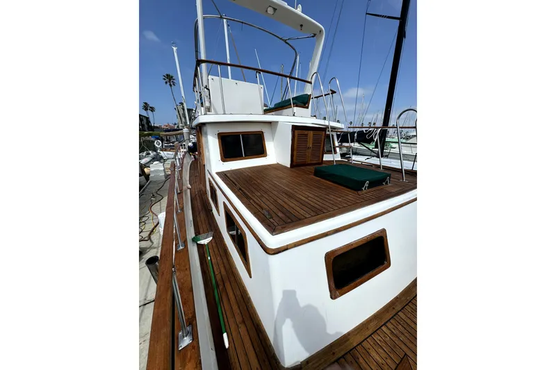 Slide: The Image of 1985 PT Boats PT 38 Aft Cabin with wooden deck, docked at marina. - 3