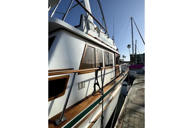 Slide: The Image of 1985 PT Boats PT 38 Aft Cabin docked, showcasing sleek design and wooden accents. - 6