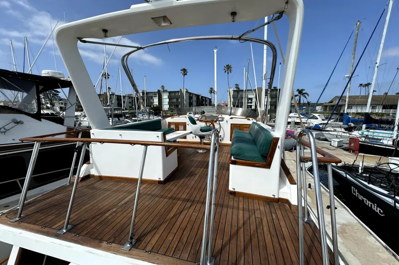 Slide: The Image of Aft cabin of 1985 PT Boats PT 38, featuring wooden deck and marina view. - 7