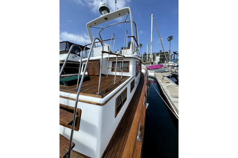 Slide: The Image of 1985 PT Boats PT 38 Aft Cabin docked, showcasing wooden deck and sleek design. - 8