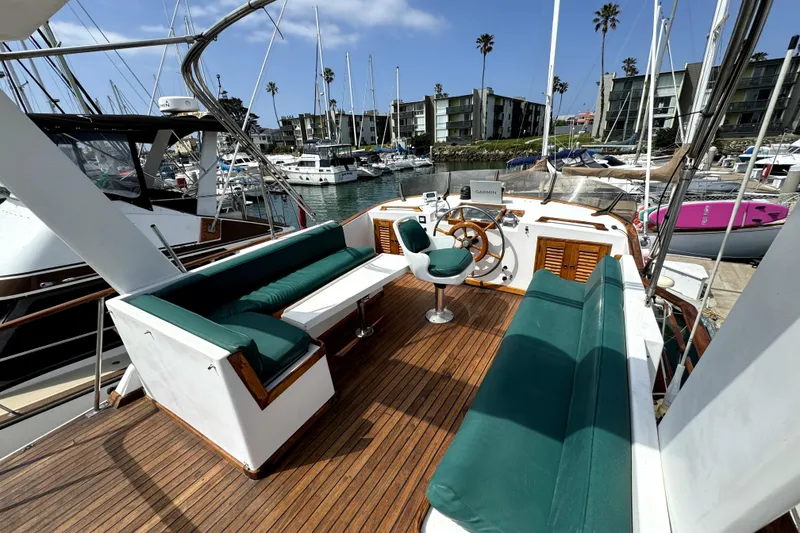 Slide: The Image of 1985 PT Boats PT 38 Aft Cabin with green seating, docked in a marina. - 9