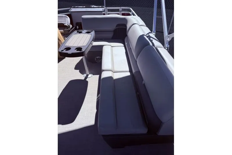Slide: The Image of 2026 Sun Tracker Sportfish 24 XP3 boat interior with gray seating and a table. - 6
