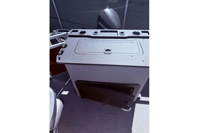 Slide: The Image of 2026 Sun Tracker Sportfish 24 XP3 boat console with storage and cup holders. - 7