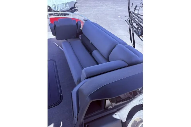 Slide: The Image of 2026 Sun Tracker Sportfish 24 XP3 boat interior with comfortable blue seating. - 8