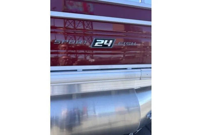 Slide: The Image of 2026 Sun Tracker Sportfish 24 XP3 pontoon boat, maroon exterior detail. - 3