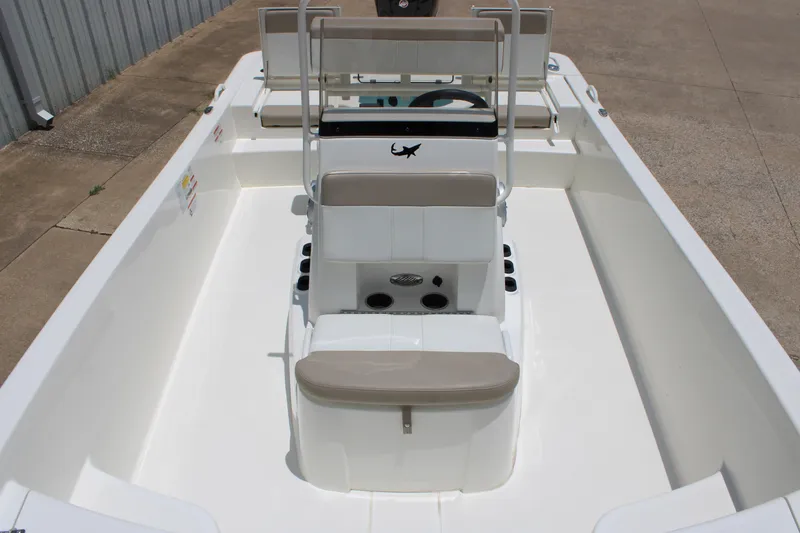 Slide: The Image of 2026 Mako Pro Skiff 19 CC boat interior with seating and steering console. - 5