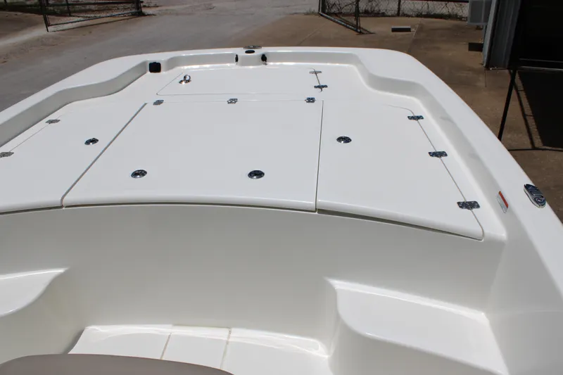 Slide: The Image of 2026 Mako Pro Skiff 19 CC boat deck with storage compartments, white finish. - 92