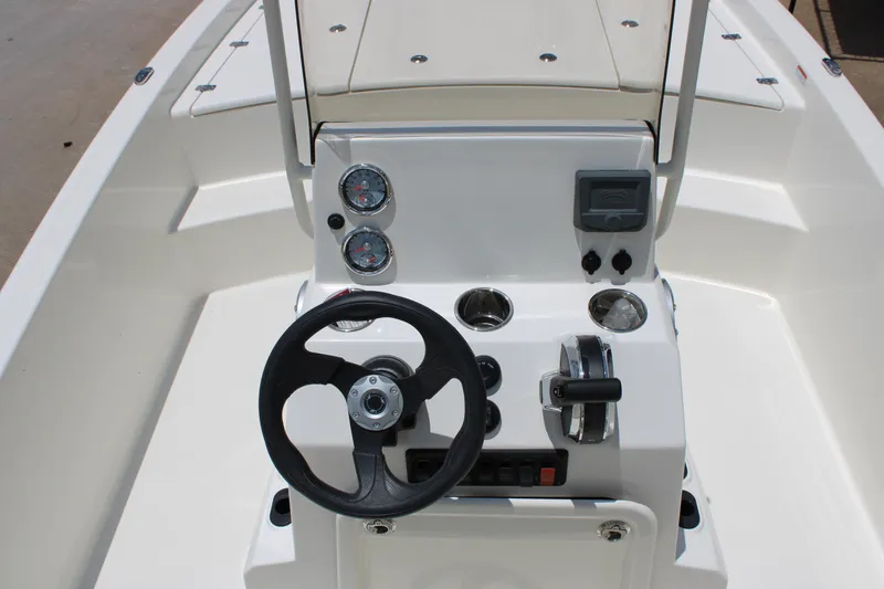 Slide: The Image of 2026 Mako Pro Skiff 19 CC boat console with steering wheel and gauges. - 4