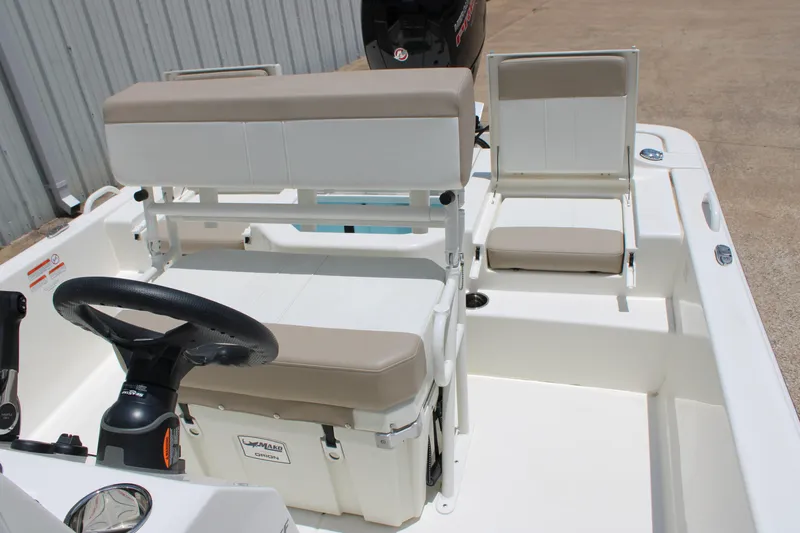 Slide: The Image of 2026 Mako Pro Skiff 19 CC boat interior with steering wheel and seating arrangement. - 8