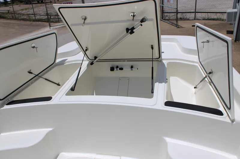 Slide: The Image of 2026 Mako Pro Skiff 19 CC boat storage compartments open, showcasing ample space. - 7