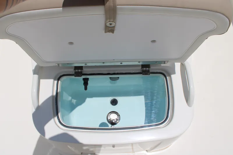 Slide: The Image of Open storage compartment on 2026 Mako Pro Skiff 19 CC boat. - 6