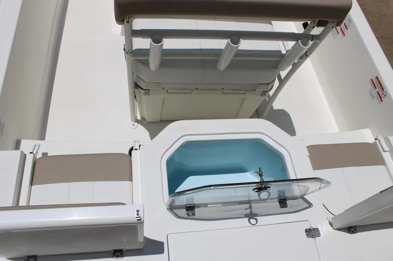 Slide: The Image of 2026 Mako Pro Skiff 19 CC interior with seating and storage compartments. - 9