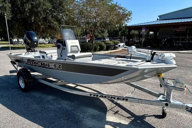 Slide: The Image of 2026 Tracker Bass Tracker Classic CC boat on trailer in sunny outdoor setting. - 2