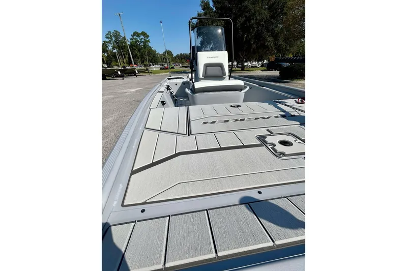 Slide: The Image of 2026 Tracker Bass Tracker Classic CC boat with sleek deck design in a sunny outdoor setting. - 9