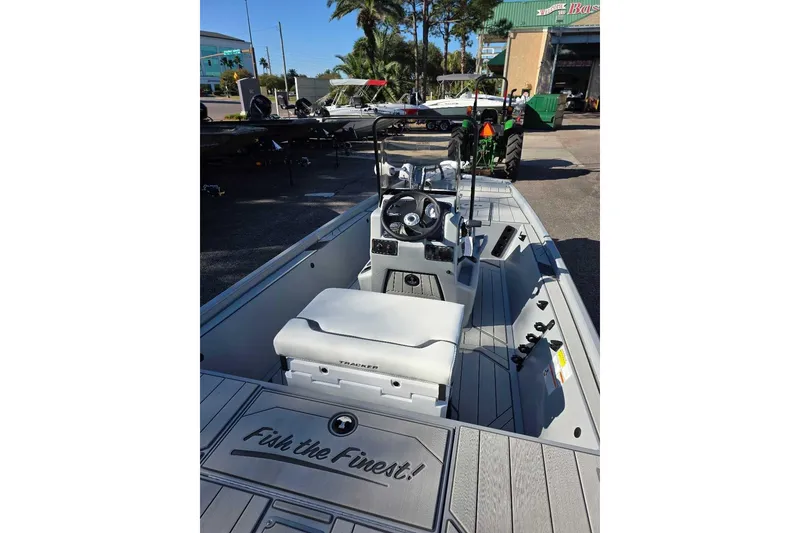 Slide: The Image of 2026 Tracker Bass Tracker Classic CC boat interior with steering console and seating. - 2