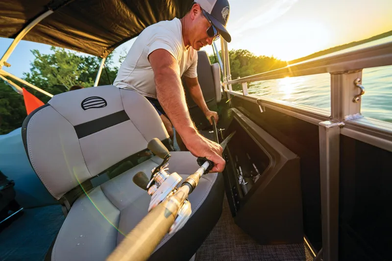 Slide: The Image of 2026 Sun Tracker Sportfish 24 XP3 pontoon boat interior with steering console and seating. - 9