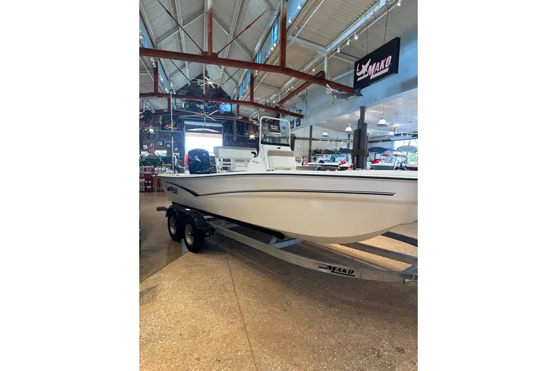 Slide: The Image of 2026 Mako Pro Skiff 19 CC boat interior in showroom setting. - 3