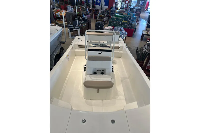 Slide: The Image of 2026 Mako Pro Skiff 19 CC boat interior with steering wheel and controls. - 4