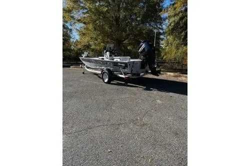 Slide: The Image of 2026 Tracker Bass Tracker Classic CC boat parked outdoors on a sunny day. - 2