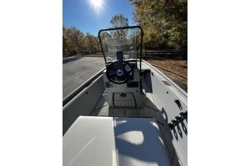 Slide: The Image of 2026 Tracker Bass Tracker Classic CC boat interior with steering console, under sunny sky. - 5
