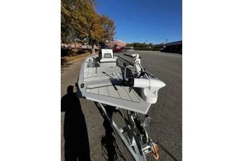 Slide: The Image of 2026 Tracker Bass Tracker Classic CC boat on trailer, parked outdoors under clear blue sky. - 6