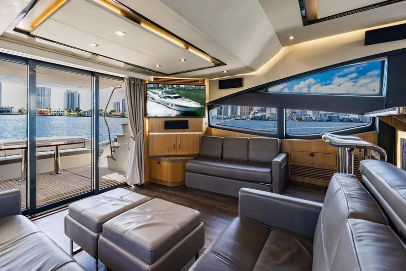 Slide: The Image of Luxurious interior of 2016 Sea Ray L650 Fly yacht with modern seating and panoramic windows. - 14