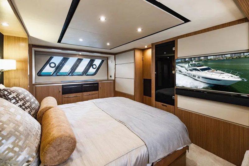 Slide: The Image of Luxurious bedroom interior of 2016 Sea Ray L650 Fly yacht with modern design and large windows. - 22