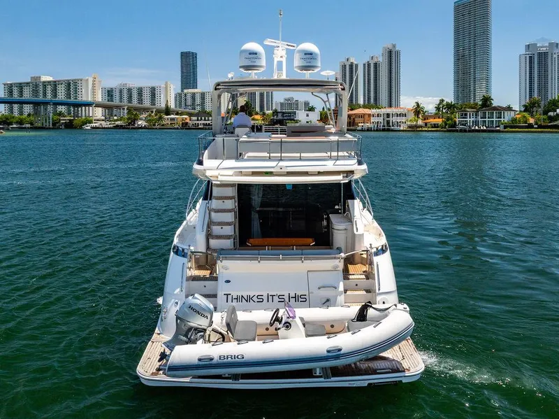 Slide: The Image of 2016 Sea Ray L650 Fly yacht on water, city skyline in background. - 33