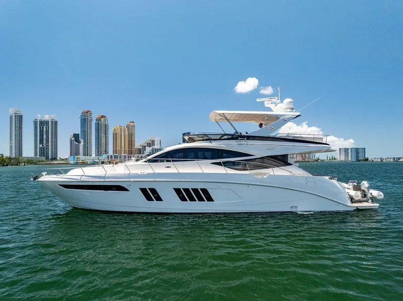 Slide: The Image of 2016 Sea Ray L650 Fly yacht cruising near city skyline on a sunny day. - 35