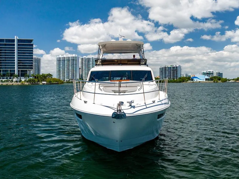 Slide: The Image of 2016 Sea Ray L650 Fly yacht on water, city skyline in background. - 36