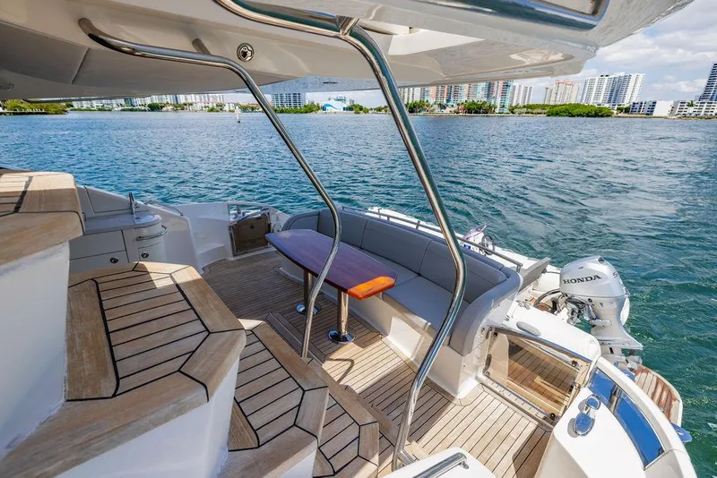 Slide: The Image of Luxurious 2016 Sea Ray L650 Fly yacht deck with seating, overlooking serene waterfront views. - 44