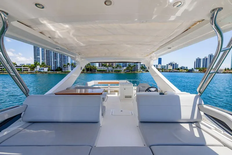 Slide: The Image of 2016 Sea Ray L650 Fly yacht interior with city skyline and blue water backdrop. - 50