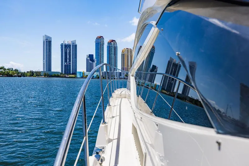 Slide: The Image of 2016 Sea Ray L650 Fly yacht cruising near city skyline on a sunny day. - 57