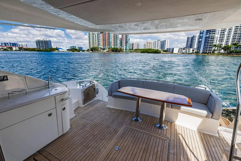 Slide: The Image of Luxurious 2016 Sea Ray L650 Fly yacht deck with waterfront cityscape view. - 7