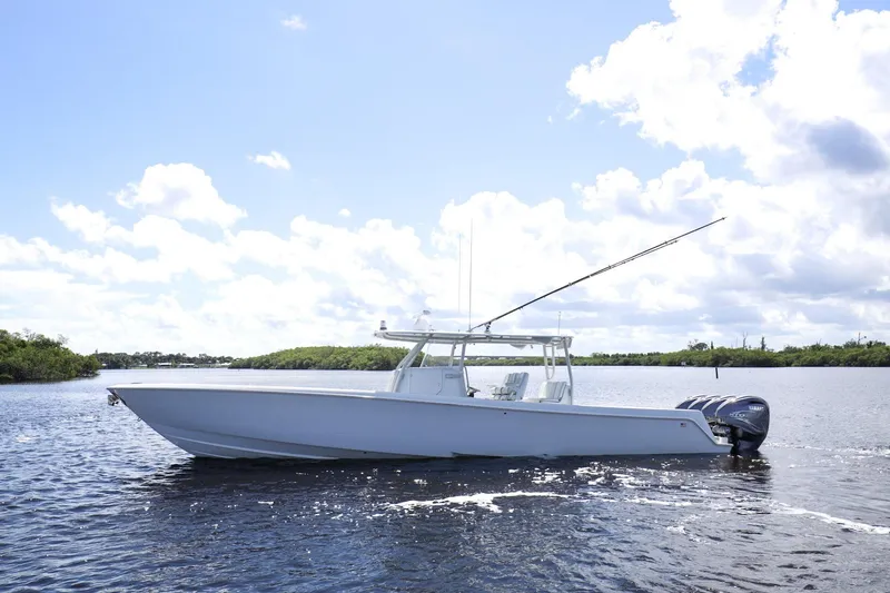 The Image of 2023 Contender 44 ST boat on calm water under a bright sky. - 0