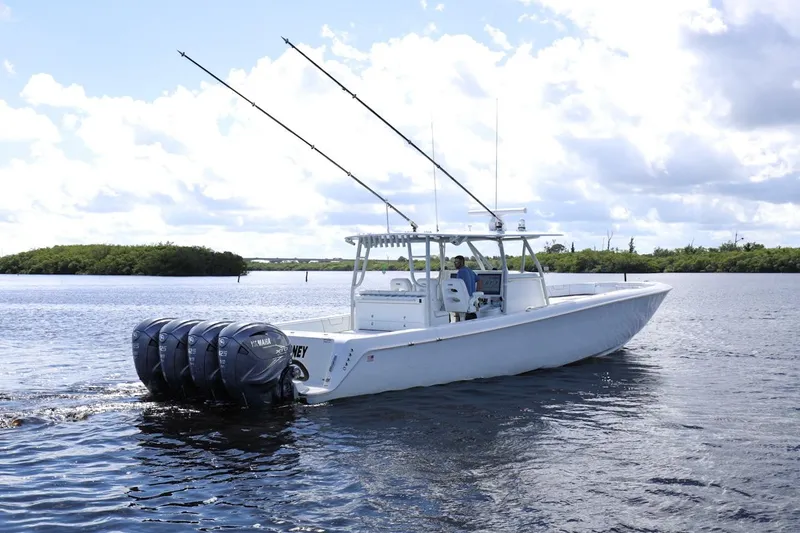 Slide: The Image of 2023 Contender 44 ST boat with four Yamaha engines on calm water. - 1