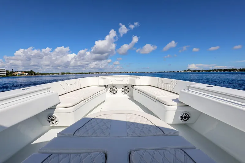 Slide: The Image of 2023 Contender 44 ST boat interior with white seating, on a sunny day at sea. - 10