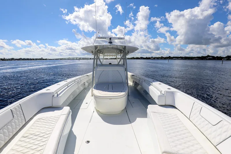 Slide: The Image of 2023 Contender 44 ST boat on open water under a blue sky with clouds. - 15