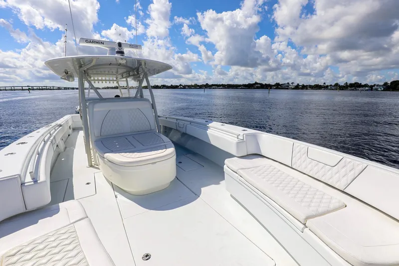 Slide: The Image of 2023 Contender 44 ST boat with spacious seating on a sunny day. - 16