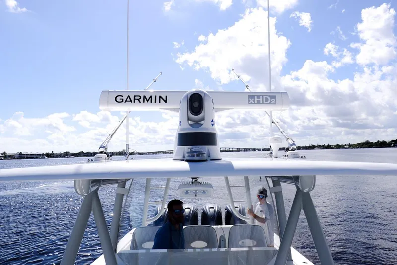 Slide: The Image of 2023 Contender 44 ST boat with Garmin xHD2 radar on open water under blue sky. - 17