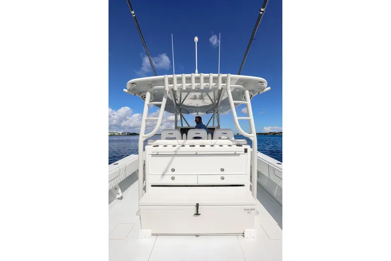 Slide: The Image of 2023 Contender 44 ST boat with center console, white seating, and blue sky background. - 18
